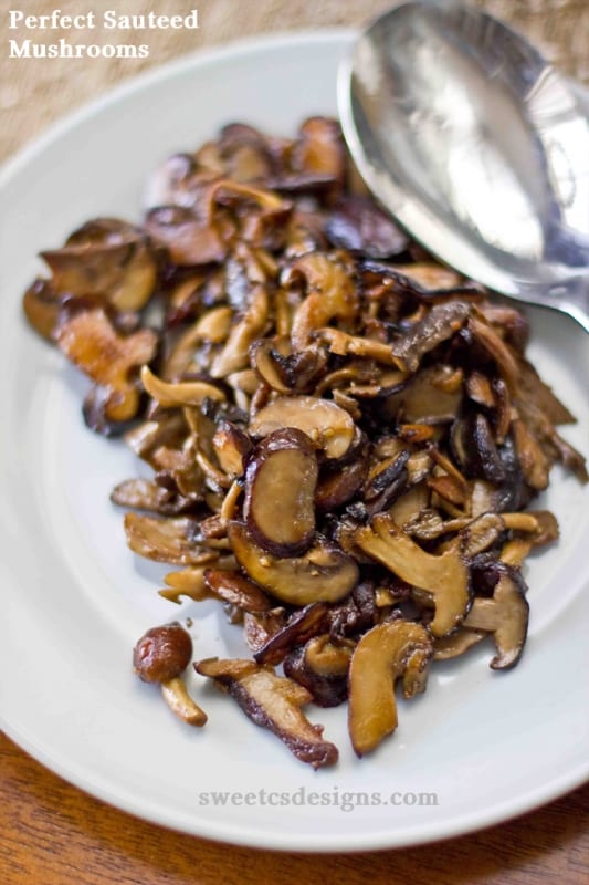 picture of sauteed mushrooms on a white plate with a spoon